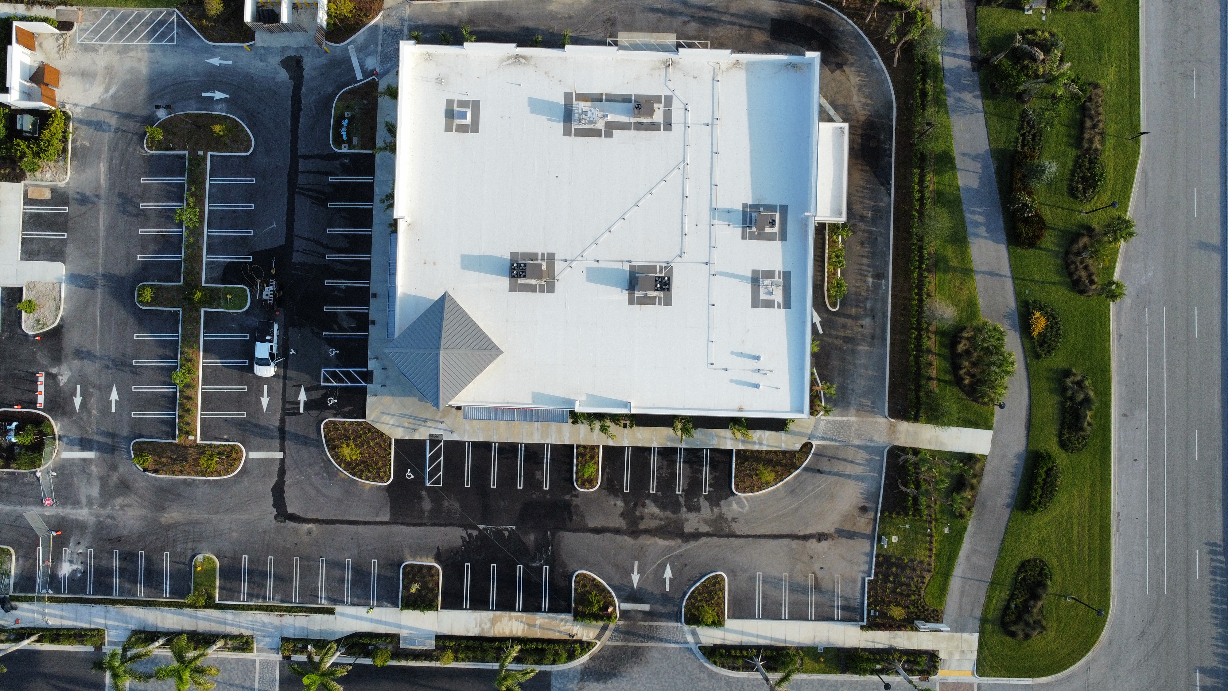 Supreme Cleaning technician approaching a post-construction pressure washing project with professional equipment